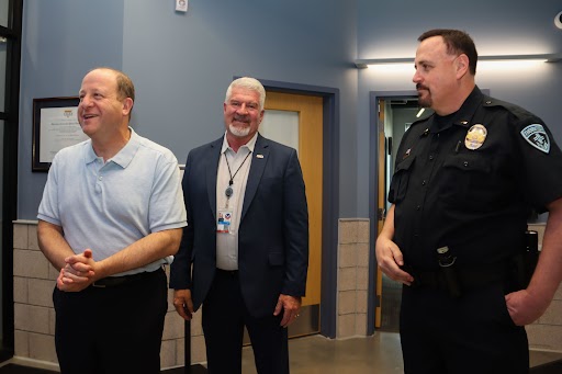 A photo of Governor Polis, Colorado Department of Public Safety Executive Director Stan Hilkey, and a Lieutenant Jim Gerhardt of the Thornton Police Department.  